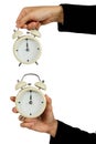 Hand of business hold alarm clock with showing 12 o`clock isolated on white - Time concept