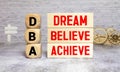 Hand of a business man completing the puzzle with the last missing piece. Business Acronym DBA Royalty Free Stock Photo