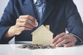 Hand of Business man holding coin put in piggy bank with money stack growing growth saving money, Concept invesment for financial Royalty Free Stock Photo