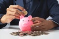 Hand of Business man holding coin put in piggy bank with money stack growing growth saving money, Concept invesment for financial Royalty Free Stock Photo