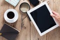 Hand business man holding and use tablet on wooden office desk a Royalty Free Stock Photo