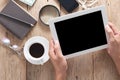 Hand business man holding and use tablet on wooden office desk a Royalty Free Stock Photo