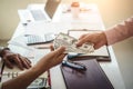 Hand of business man giving money for taking bribe while making contract. bribery and corruption concept Royalty Free Stock Photo