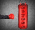 A hand in business suit is hitting the red punching bag. Royalty Free Stock Photo