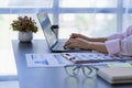 hand of business woman hold smartphone use analyzing and calculating the annual income Royalty Free Stock Photo