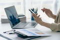 hand of business woman hold smartphone use analyzing and calculating the annual income Royalty Free Stock Photo