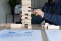 Hand of business woman, leader building stacked jenga tower Royalty Free Stock Photo