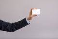 Hand of a businessman with a blank card