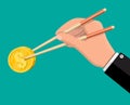 Hand of businessman with chopsticks with coin Royalty Free Stock Photo