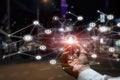 Hand of a businessman demonstrates the network on a blurred background of the city