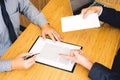 Hand of a businessman hands over a resignation letter final remuneration to executive boss on a wooden table to his boss Change of Royalty Free Stock Photo