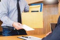 Hand of a businessman hands over a resignation letter final remuneration to executive boss on a wooden table to his boss Change of Royalty Free Stock Photo