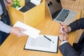 Hand of a businessman hands over a resignation letter final remuneration to executive boss on a wooden table to his boss Change of Royalty Free Stock Photo