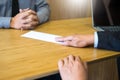 Hand of a businessman hands over a resignation letter final remuneration to executive boss on a wooden table to his boss Change of Royalty Free Stock Photo