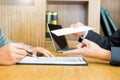 Hand of a businessman hands over a resignation letter final remuneration to executive boss on a wooden table to his boss Change of Royalty Free Stock Photo