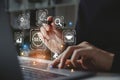 Hand of businessman holding a pen pointing to SEO Search Engine Optimization on laptop screen Royalty Free Stock Photo