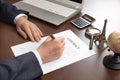 Hand of businessman holding pen in hand and signing contract document Royalty Free Stock Photo