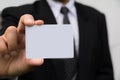 Hand of businessman holding the white card on white. Royalty Free Stock Photo