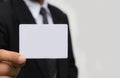 Hand of businessman holding the white card on white. Royalty Free Stock Photo