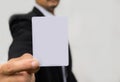 Hand of businessman holding the white card on white. Royalty Free Stock Photo