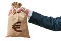 Hand of businessman holds bag full of money with Euro sign. Royalty Free Stock Photo