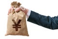 Hand of businessman holds bag full of money with Yen sign. Royalty Free Stock Photo