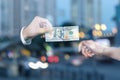 Hand of businessman holds out a hundred dollars to a businesswoman Royalty Free Stock Photo