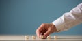 Hand of a businessman placing five blank wooden dices in a row Royalty Free Stock Photo