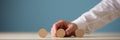 Hand of a businessman placing three blank wooden cut circles in a row