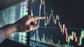 hand of a businessman pointing at a candle stick graph chart of stock market investment trading app.