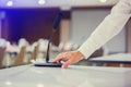 The hand of businessman is pressing to power on wireless Conference microphones in a meeting room