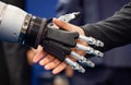 Hand of a businessman shaking hands with a Android robot Royalty Free Stock Photo