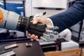 Hand of a businessman shaking hands with a Android robot Royalty Free Stock Photo