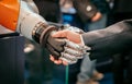 Hand of a businessman shaking hands with a Android robot Royalty Free Stock Photo