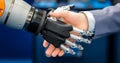 Hand of a businessman shaking hands with a droid robot. The concept of human interaction with artificial intelligence. Royalty Free Stock Photo