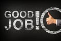 Hand of a businessman showing thumbs up for the phrase Good Job! written on a blackboard Royalty Free Stock Photo