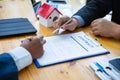 Hand of businessman are signing contract agreement document, Home loan,buy new home,moving home or renting property concept Royalty Free Stock Photo