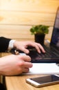 Hand of businessman in suit on keyboard filling and signing with