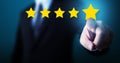 Hand of businessman touching five star symbol to increase rating of company concept Royalty Free Stock Photo