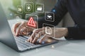 Hand of businessman using laptop with caution warning sign Royalty Free Stock Photo