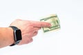 Hand of businessman with watch holding money