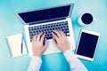 Hand of businessman working on laptop computer with tablet and notebook on desk in office. Royalty Free Stock Photo