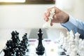 hand of businessmen moving chess in competition shows leadership, followers and business success strategies