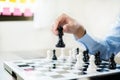hand of businessmen moving chess in competition shows leadership, followers and business success strategies