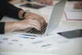 Hand of businessmen used laptop while Group discussing on stockmarket charts at office desk, they are business analyzing. Royalty Free Stock Photo