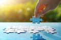 Hand of businesswoman connecting jigsaw puzzle piece on blue table with sunlight