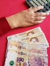 hand of a businesswoman counting argentinean banknotes