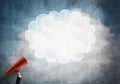 Hand of businesswoman holding red paper trumpet and speech cloud