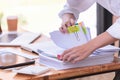 Hand of a businesswoman working for searching in Stacks of paper documents on wooden desks at the workplace Royalty Free Stock Photo