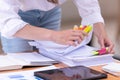 Hand of a businesswoman working for searching in Stacks of paper documents on wooden desks at the workplace Royalty Free Stock Photo